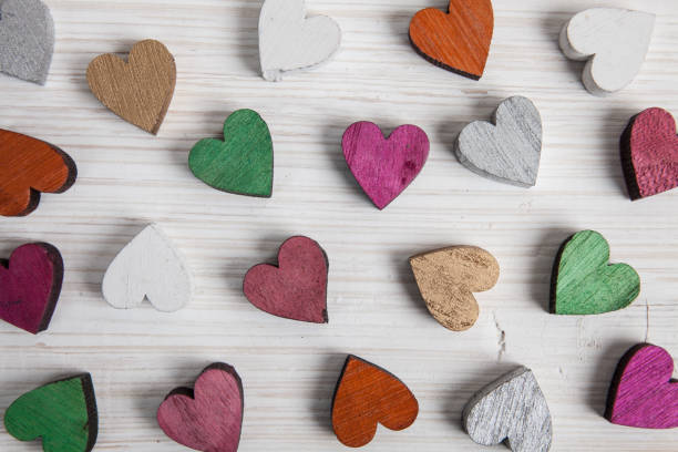 istock A colorful hearts on white wooden background 1097210440