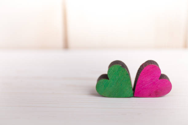 A colorful hearts on a wooden background stock photo