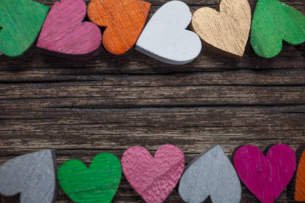 Valentines day card. A colorful hearts on a old wooden background. Copy space for text. stock photo
