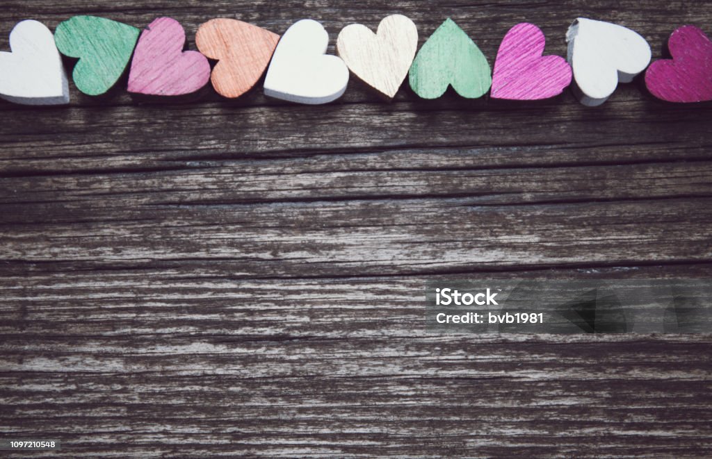 Valentines day card. A colorful hearts on a old wooden background. Copy space for text. Valentines day card. A colorful hearts on a old wooden background. Copy space for your text. Above Stock Photo