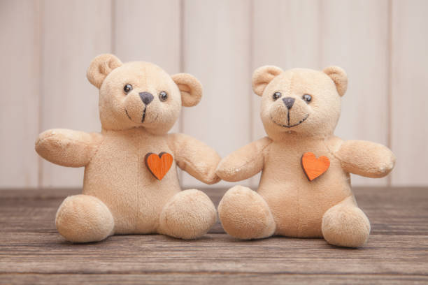 Couple Teddy Bears on wooden background. Valentines Day card. Love heart. stock photo