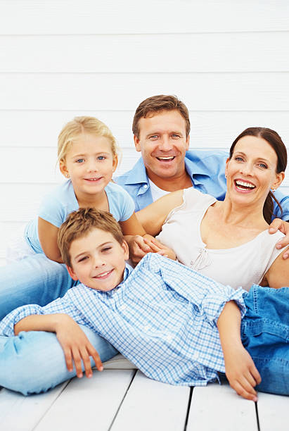 istock Happy family relaxing outdoors against wall 109721113