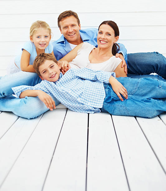 istock Happy family relaxing outdoors against wall 109721119