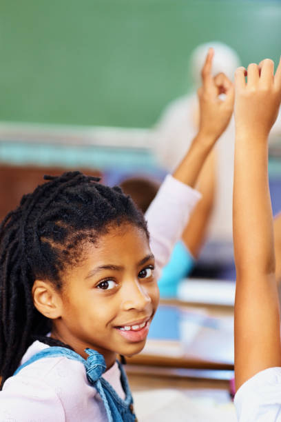 istock Smiling girl raising hand to answer the question 109721234