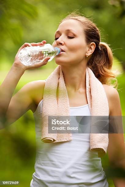 Woman Drinking Water After Sport Activities Stock Photo - Download Image Now - 25-29 Years, Adult, Adults Only