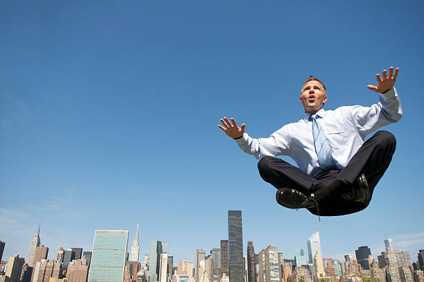 istock Levitating Businessman Floating Above City Skyline 109721598