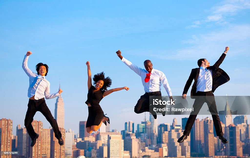 Happy Successful business people celebrating by jumping in New York  Jumping Stock Photo