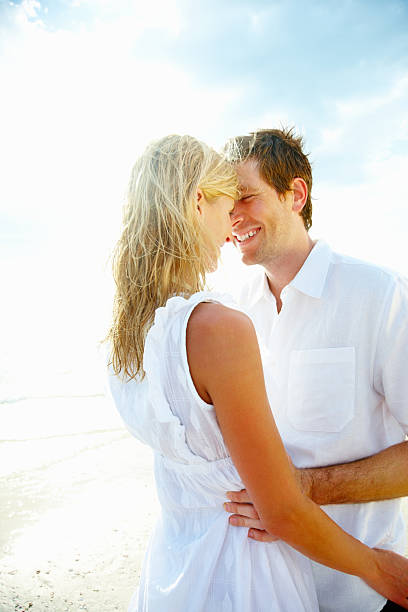 istock Young romantic man embracing a pretty woman on seashore 109721827
