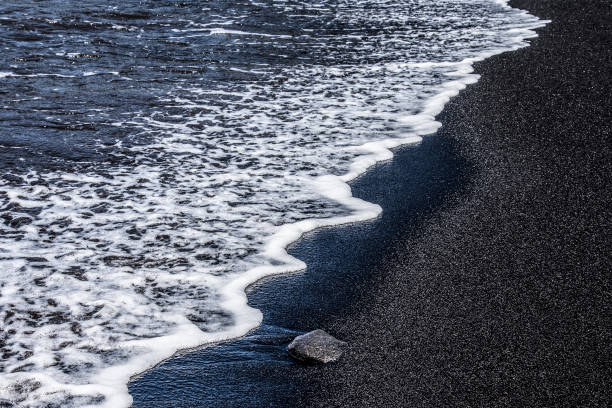 The ocean on the black sand beach in Big Island, Hawaii
