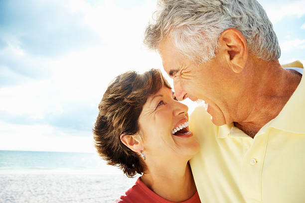 istock Happy romantic mature couple looking at each other on beach 109721996