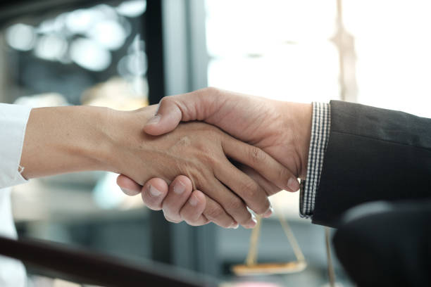 istock Lawyer handshake with client. Business partnership meeting successful concept. 1097219988