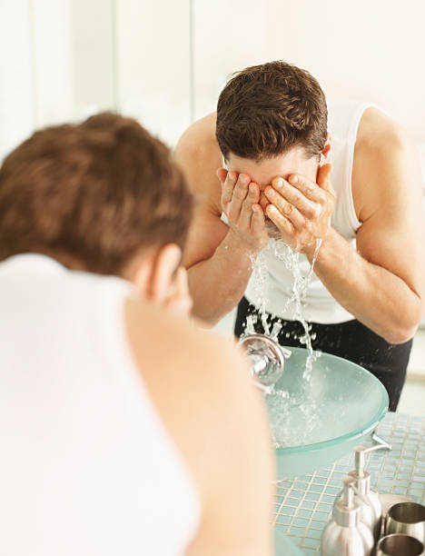 istock Guy washing his face in front of mirror 109722117