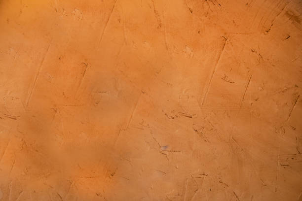 istock Organgish rough stucco mud grunge background where you can see the marks where it been applied 1097222206