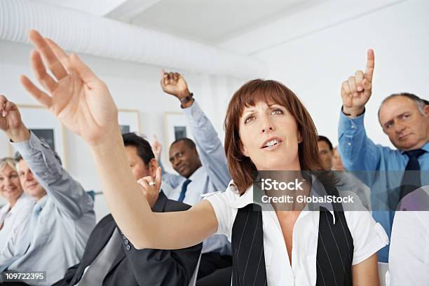 Multiethnic Executives Raising Their Hands In Business Meeting Stock Photo - Download Image Now