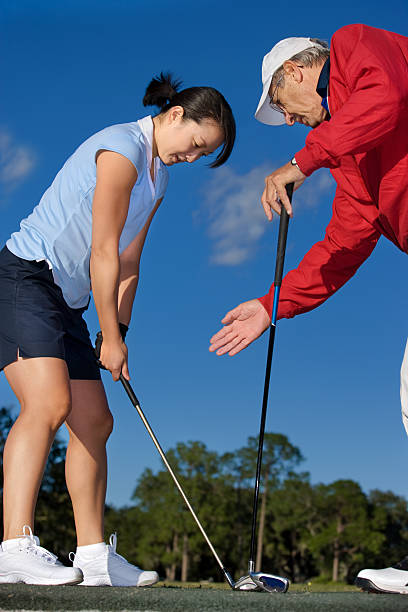 istock Golf pro teaching young female golfer 109722466