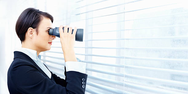 istock Female executive looks through binoculars in office - copyspace 109722505