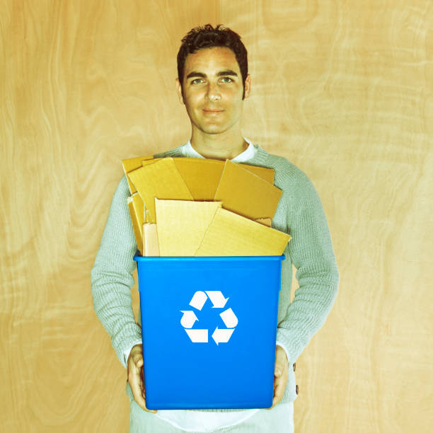 istock Man holding a recycling bin full of cardboard 109722561