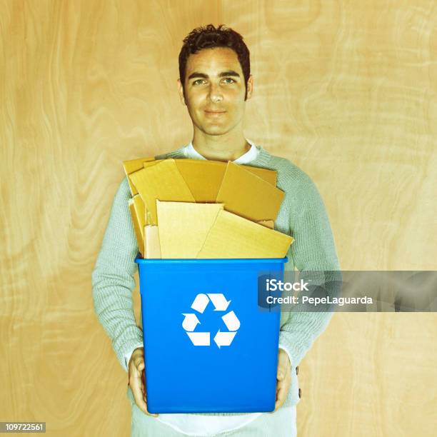 Man Holding A Recycling Bin Full Of Cardboard Stock Photo - Download Image Now - 25-29 Years, Adult, Adults Only