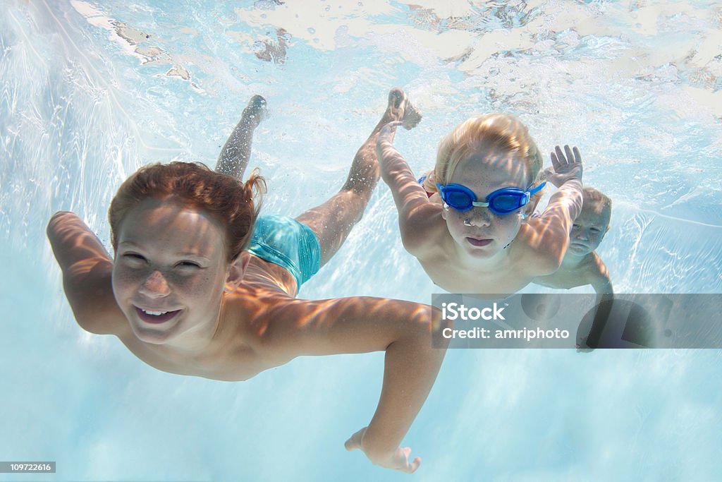 boys in swimming pool, underwater  Swimming Stock Photo