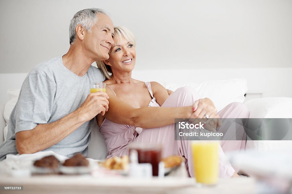 Happy mature couple with a glass of juice  50-59 Years Stock Photo