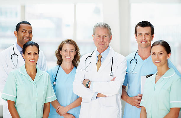 istock Group of doctors smiling against blur background 109722742