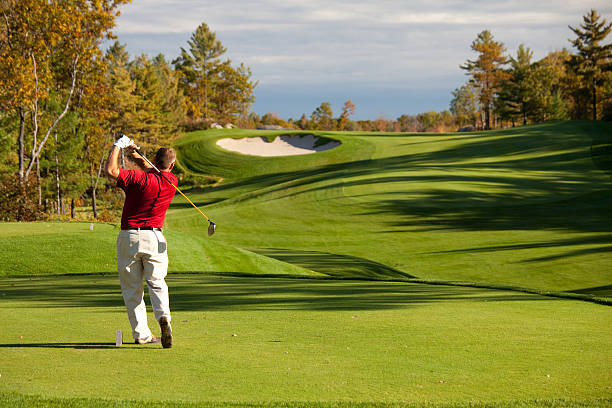 Senior Male Caucasian Golfer Driving off the Tee in Fall  golf course stock pictures, royalty-free photos & images
