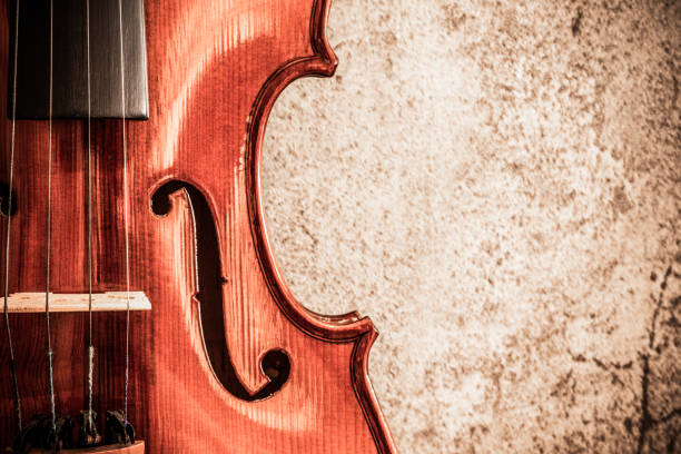 istock violin on cement wall, music background 1097229754