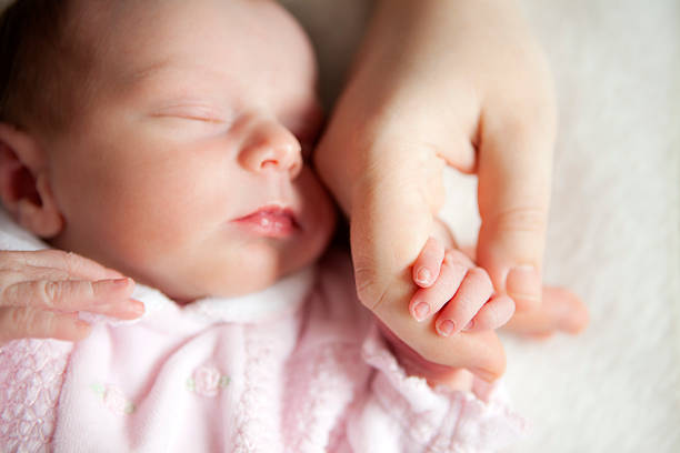 istock Newborn baby holding mother's hand 109722991