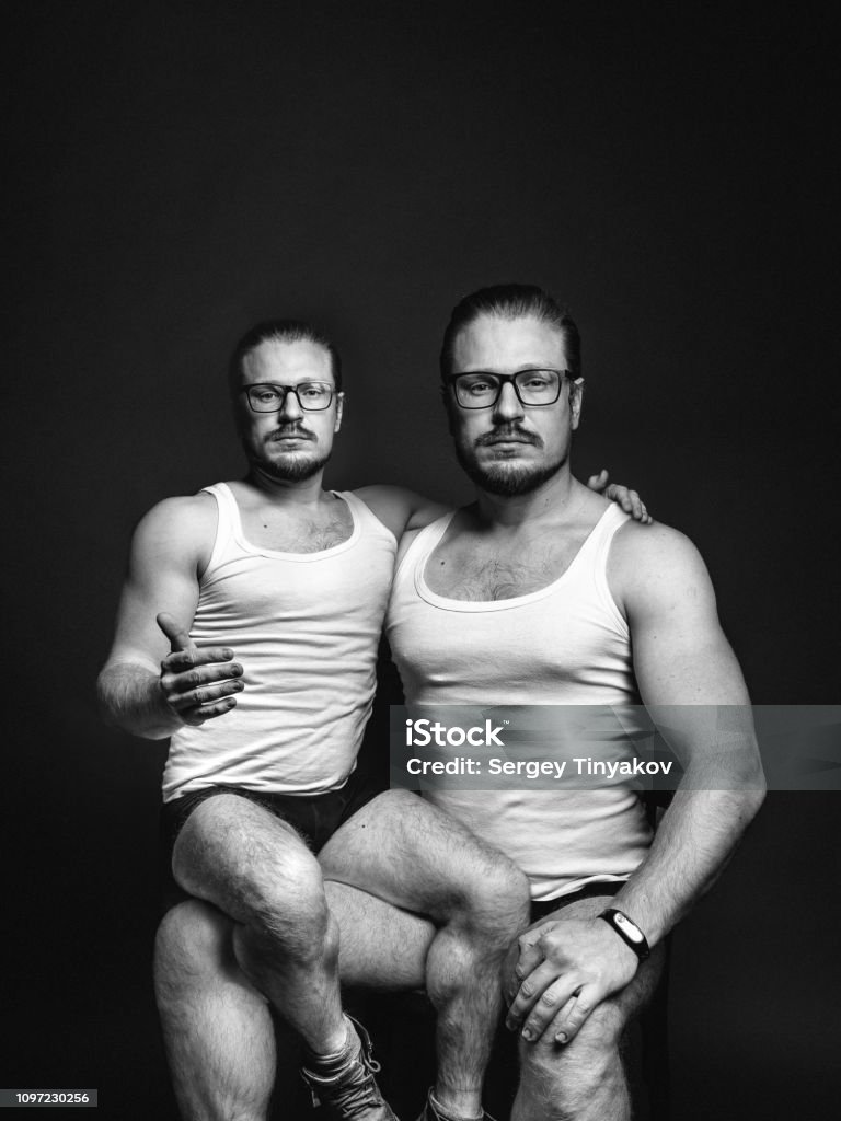 Creative man portrait. Concept of cloning people. Black and white image with scratches Creative male portrait. The concept of cloning people. Black and white image with scratches Teamwork Stock Photo