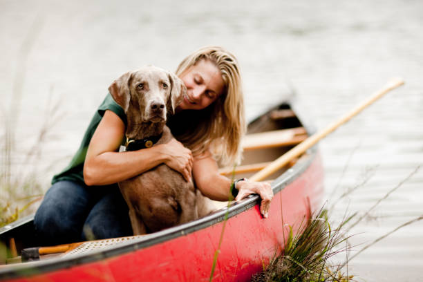istock Woman Hugging Dog in a Canoe 109723128