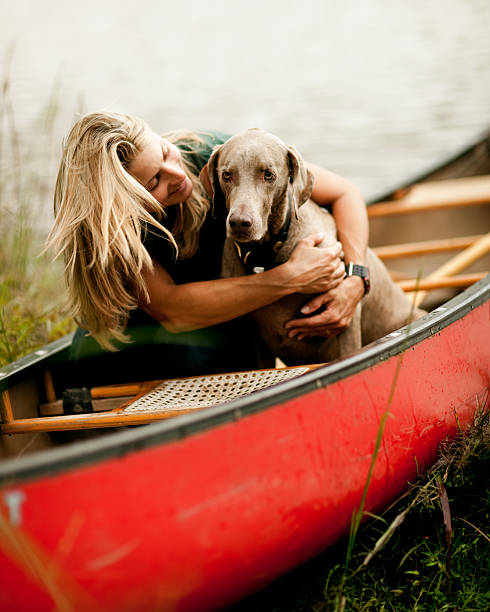 istock Woman Hugging Dog in a Canoe 109723129