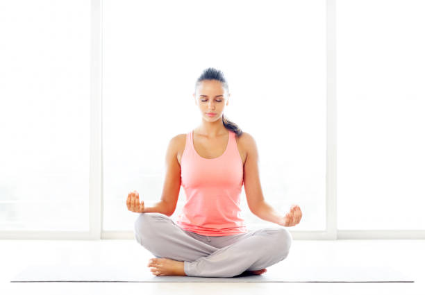 istock Lotus position - Young casual woman practicing yoga 109723169