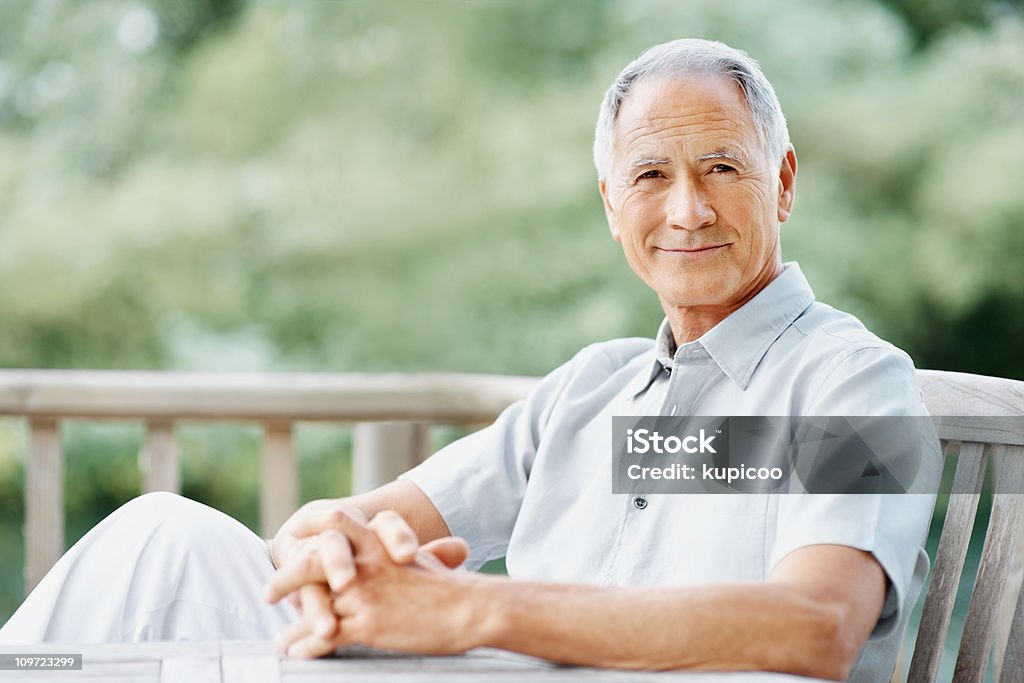 An elderly man sitting on a wooden bench  Active Seniors Stock Photo