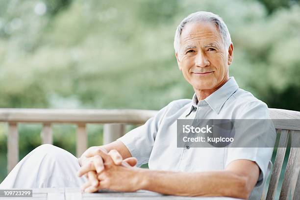 An Elderly Man Sitting On A Wooden Bench Stock Photo - Download Image Now - Active Seniors, Adult, Adults Only
