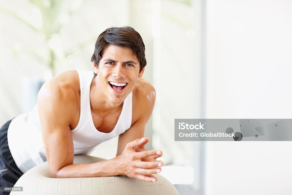 Young fitness male exercising on a ball  20-24 Years Stock Photo