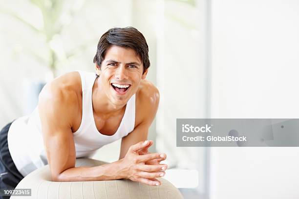 Young Fitness Male Exercising On A Ball Stock Photo - Download Image Now - 20-24 Years, 20-29 Years, Active Lifestyle