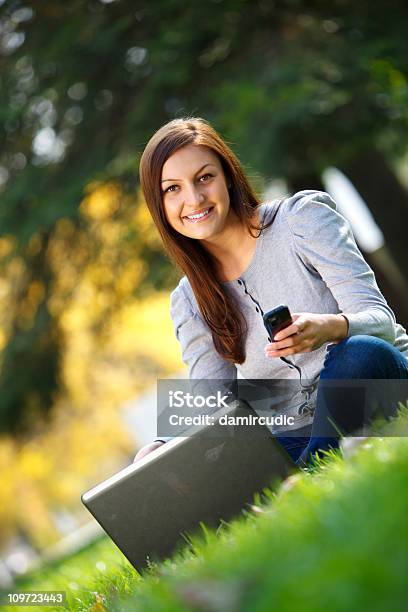 Joven Mujer En La Naturaleza Utilizando Teléfono Celular Foto de stock y más banco de imágenes de Ordenador portátil