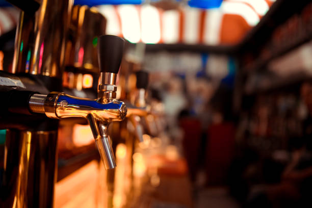 istock Hand of bartender pouring a large lager beer in tap. 1097236080