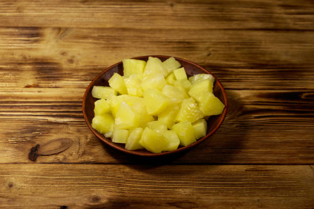 istock Canned pineapple pieces in ceramic plate on wooden table 1097236298