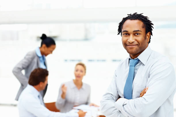 istock Confident businessman with colleagues working in the background 109723994