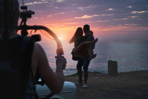 silhouette of photographer taking picture of landscape during sunrise