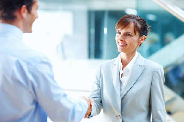 istock Pretty business woman shaking hands with man 109724216
