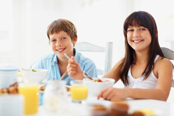 istock Young girl and boy having a healthy breakfast 109724326