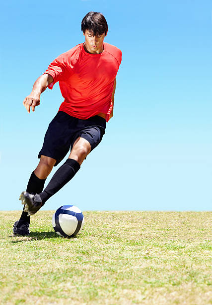 istock Soccer player dribbling a ball on the field 109724394