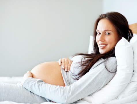 Pregnant young woman relaxing on the sofa at home.