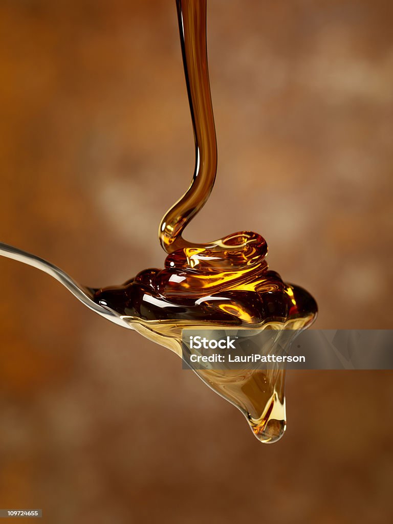 Pouring Maple Syrup over a Spoon  Honey Stock Photo