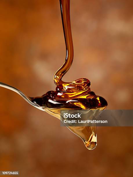 Pouring Maple Syrup Over A Spoon Stock Photo - Download Image Now - Honey, Maple Syrup, Pouring