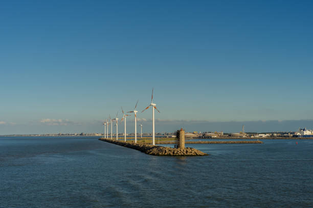 ветровые турбины возле гавани в промышленной зоне - belgium bruges windmill europe стоковые фото и изображения