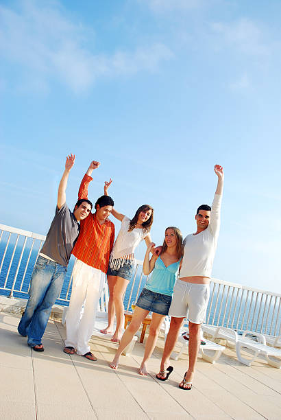 istock Group of Young People on Beach Deck 109724679