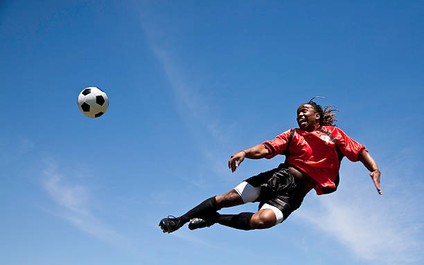 istock Soccer Player Kicking the ball in sky 109724681